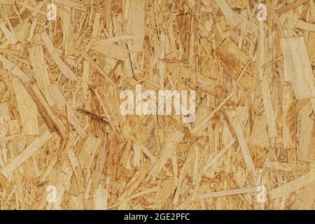 Recyceltes komprimiertes Holzspanplatten-Brett, Strangplatten-Nahaufnahme, Faserplatten-Textur, Holzhintergrund Stockfoto