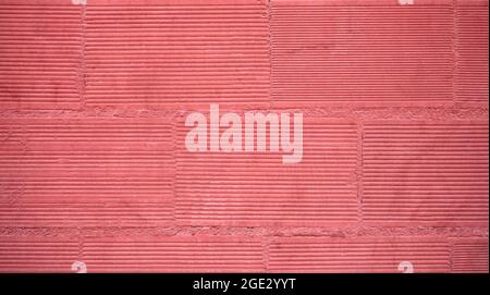 Detail einer Backsteinwand, rot gestrichen Stockfoto