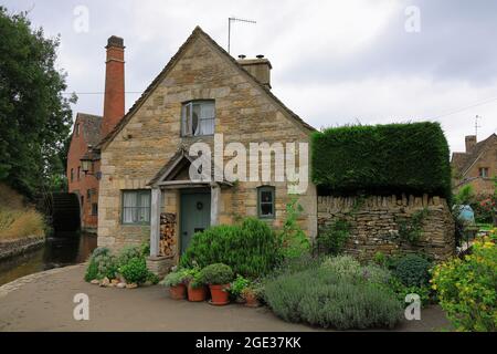 Traditionelles Steinhaus vor der Old Mill in Lower Slaughter im britischen Cotswolds Stockfoto