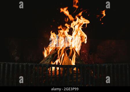 Flammen im Herd eines offenen Kamins, die ein Familienhaus erwärmen Stockfoto