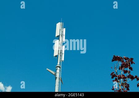 Blick auf eine Telecommunication Tower-Antenne des 4G- und 5G-Mobilfunksystems auf einem Gebäude in Bellinzona, Schweiz Stockfoto