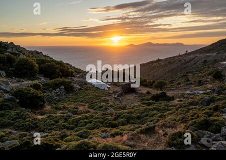 Sonnenuntergang über dem Meer, Landschaft mit Macchia, auf den hinteren Inseln Gyali und Kos, Nisyros, Dodekanes, Griechenland Stockfoto