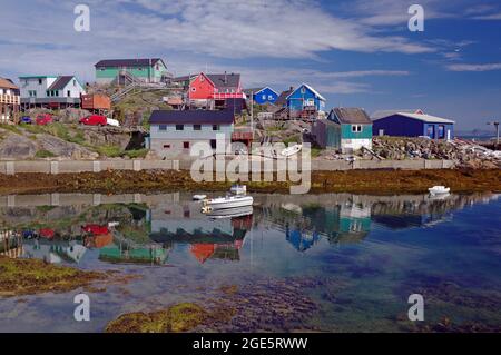 Bunte Häuser spiegeln sich im stillen Wasser des Fjords, Sommertag, Maniitsoq, Grönland, Dänemark Stockfoto