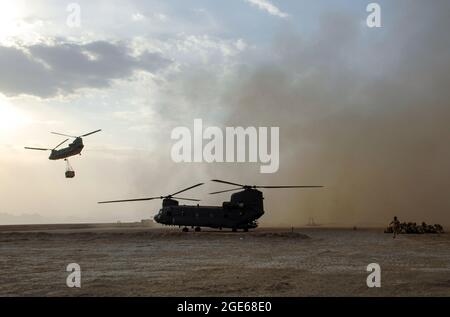 Chinook Helicopter lässt britische Truppen und Lieferungen in der Provinz Helmand, Afghanistan, fallen. Stockfoto