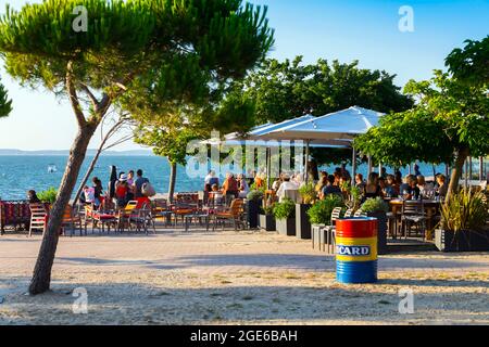 Arcachon (Südwestfrankreich): Touristen sitzen auf den Terrassen von Cafés und Restaurants in der Nähe des Pereire-Strandes. Stockfoto
