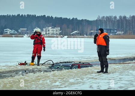 Das Auto brach in das Eis ein und ertrank im See. Arbeit des Rettungsdienstes Stockfoto