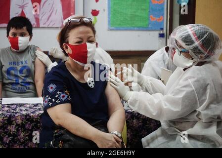 Jakarta, Indonesien. August 2021. Eine Gesundheitsarbeiterin gibt einer Frau in Jakarta, Indonesien, am 17. August 2021 eine Dosis des COVID-19-Impfstoffs. Quelle: Arya Manggala/Xinhua/Alamy Live News Stockfoto