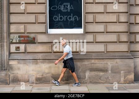 Edinburgh, Schottland, Großbritannien. August 2021. Das Mitglied der Öffentlichkeit geht an den umfirmenden Abrdn-Büros in der George Street in Edinburgh vorbei. Iain Masterton/Alamy Live Nachrichten. Stockfoto