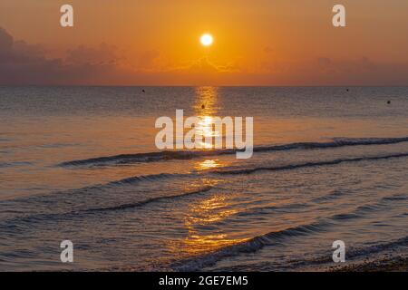 Langrune-Sur-Mer, Frankreich - 08 03 2021: Sonnenaufgang über dem Meer vom Strand Stockfoto