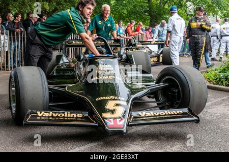 Classic Lotus 79 Formel 1, Grand-Prix-Rennwagen beim Goodwood Festival of Speed Rennsport-Event 2014. Classic Team Lotus Crew schiebt Auto Stockfoto