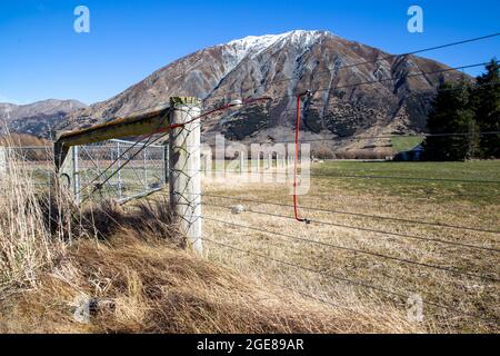 Elektrischer Farmzaun im Hochland, Canterbury, Neuseeland Stockfoto