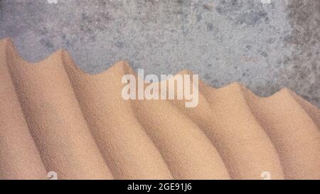 Sand Texturen Hintergrund auf dem Strand auf einer grauen Basis Stockfoto