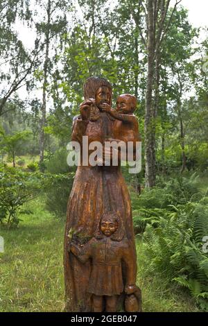 dh Blackmuir Holz STRATHPEFFER OSTERN ROSS CROMARTY Schottische geschnitzte Skulpturen auf Waldweg Schottland Stockfoto