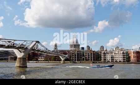 London, Greater London, England, August 10 2021: Motorboot auf der Themse fährt vor der St. Pauls Cathedral mit der Millennium Bridge. Stockfoto