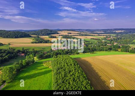 Sudetenausläufer. Hügeliges Gelände bedeckt mit Ackerfeldern, Wiesen, Baumklumpen. In der Ferne sieht man Berge am Horizont. Phot Stockfoto