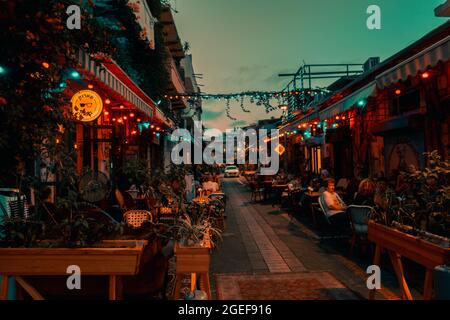 ROSH PINA, ISRAEL - Jul 16, 2021: Eine malerische Aussicht auf Touristen entlang Straße Restaurant in Rosh Pinna, Israel während der Nacht Stockfoto