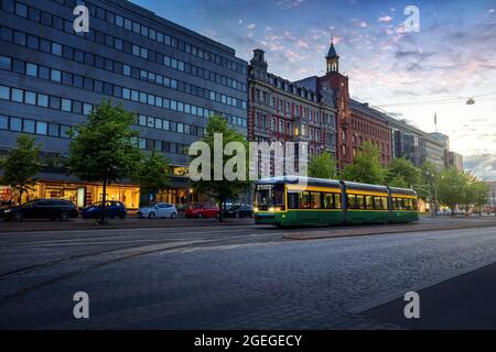 City Tram in der Mannerheimintie Straße bei Sonnenuntergang - Helsinki Hauptstraße im Stadtzentrum - Helsinki, Finnland Stockfoto
