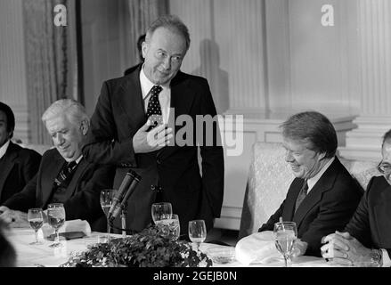 Premierminister Yitzhak Rabin aus Israel, Mitte, hält am Montag, den 7. März 1977, bei einem Arbeitsessen zu seinen Ehren, das der US-Präsident Jimmy Carter, rechts, im Staatlichen Speisesaal des Weißen Hauses in Washington, DC, veranstaltet hat, eine Rede. Links ist der Sprecher des US-Repräsentantenhauses Tip O’Neill (Demokrat von Massachusetts).Quelle: Benjamin E. 'Gene' Forte / CNP /MediaPunch Stockfoto