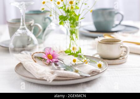 Frühling und Sommer mit frischen Blumen, Besteck und Kaffeetasse Stockfoto