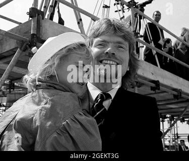 AJAXNETPHOTO. 1985. HAMBLE POINT, SOUTHAMPTON, ENGLAND. - RICHARD BRANSON MIT SEINER TOCHTER HOLLY BEI DER OFFIZIELLEN NAMENSGEBUNG UND DEM START SEINES VIRGIN ATLANTIC CHALLENGER POWER CATAMARANS IN HAMBLE POINT. FOTO;JONATHAN EASTLAND/AJAX REF:1985 21A 6 Stockfoto