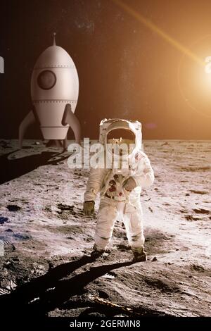 Astronaut läuft auf dem Mond vor dem Hintergrund der Spielzeugrakete. Elemente dieses Bildes, die von der NASA eingerichtet wurden. Stockfoto