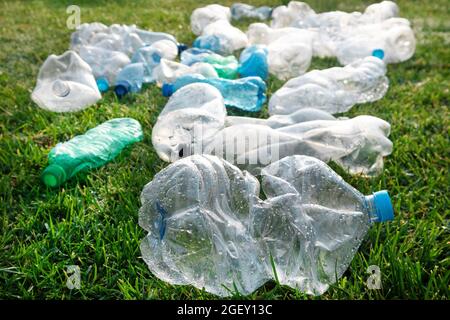 Zeichen der Unhöflichkeit benutzte Plastikflaschen, die auf einer Wiese abgelegt wurden Stockfoto