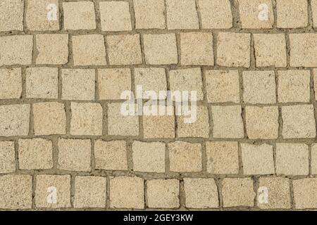 Pflastersteine aus der Nähe als Hintergrund. Blick von oben Stockfoto