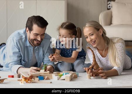 Glückliches Familienpaar und Tochter Mädchen spielen mit Spielzeug Blöcke Stockfoto