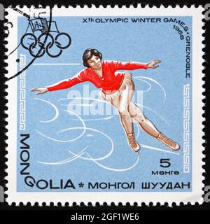 MONGOLEI - UM 1967: Eine in der Mongolei gedruckte Briefmarke zeigt Eiskunstlauf, 10. Olympische Winterspiele Ganes, Grenoble, Frankreich, um 1967 Stockfoto