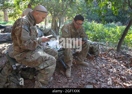 US Army Staff Sgt. Eric Cook (links) und Staff Sgt. Sean im (rechts), von 3-4 Kavallerie, 3. Brigade-Kampfteam, 25. Infanterie-Division, Eingabe von Gitterkoordinaten auf Defense Advanced GPS-Empfängern für ein anstehendes Missionsziel, während der Operation Jolo II, 26. Januar 2012, Bezirk Memlah, Provinz Nangarhar, Afghanistan. Stockfoto