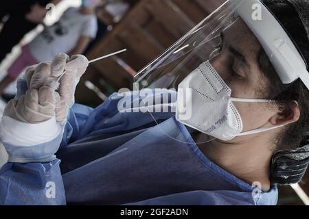 Jerusalem, Israel. August 2021. Sanitäter von Magen David Adom, der als israelische Organisation des Roten Kreuzes und führender Rettungsdienst tätig ist, führen schnelle Antigen Covid-19-Tests an den über drei Jahre alten Ungeimpften durch. Ein negatives Ergebnis verleiht einen 24-Stunden-Green Pass und Zugang zu öffentlichen Innenräumen und Veranstaltungen im Einklang mit den neu auferlegten Einschränkungen der Regierung. Ein langfristiger Green Pass wird nur an Personen vergeben, die vollständig geimpft oder vom Coronavirus geborgen sind. Israel kämpft gegen eine vierte Welle von COVID-19, die überwiegend aus der Delta-Variante besteht. Kredit: Nir Alon/Alamy Live Nachrichten Stockfoto