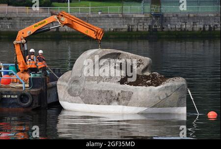 Die 27 Tonnen schwere Skulptur Floating Head aus Beton und Stahl des Künstlers Richard Groom wird etwa 33 Jahre nach ihrer Entstehung für das Glasgow Garden Festival am Fluss Clyde in der Nähe des Glasgow Science Center aufgestellt. Bilddatum: Montag, 23. August 2021. Stockfoto