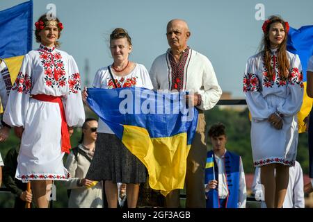 Nicht exklusiv: SAPORISCHSCHSCHJA, UKRAINE - 23, 2021 - EIN Mann und eine Frau in Wyschywankas halten am Tag des Staates eine ukrainische Flagge auf der Insel Chortyzja Stockfoto