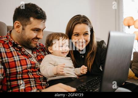 Glückliche Familie während eines Videoanrufs über den Laptop zu Hause Stockfoto