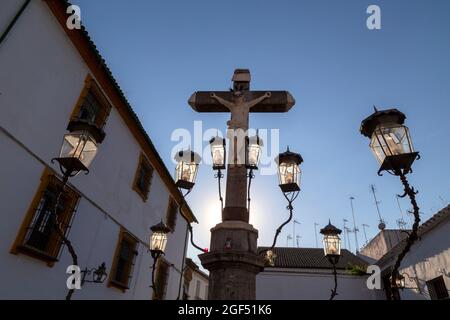 Mädchen, das den Christus der Laternen bei Sonnenuntergang auf der Plaza de Kapuzinos in Cordoba Andalusien, Spanien, betrachtet Stockfoto