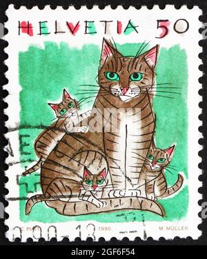 SCHWEIZ - UM 1990: Eine in der Schweiz gedruckte Briefmarke zeigt Hauskatzen, Felis Catus, Tier, um 1990 Stockfoto