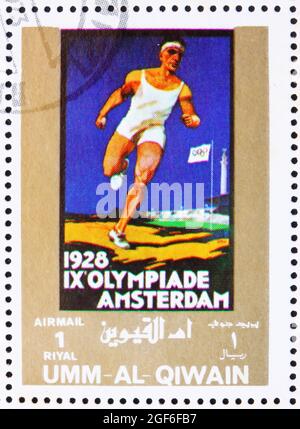 UMM AL-QUWAIN - UM 1972: Eine in Umm al-Quwain gedruckte Marke zeigt Amsterdam 1928, Niederlande, Olympische Spiele der Vergangenheit, um 1972 Stockfoto