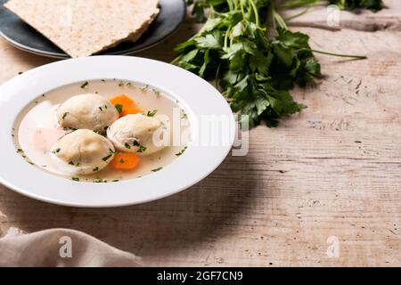 Traditionelle jüdische Matzoballsuppe auf Holztisch Stockfoto