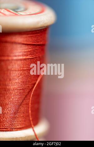 Blick auf lebendige, bunte Baumwolle auf kleinen Rollen in einer Vintage-Nähbox, Nottinghamshire, Großbritannien Stockfoto