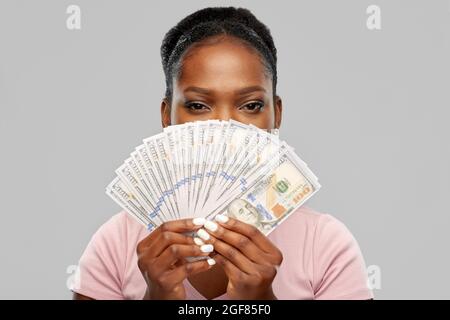 afroamerikanische Frau versteckt sich hinter Dollargeld Stockfoto