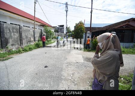 Palu, Indonesien. August 2021. Das Team der Polizei von Central Sulawesi (Gegana) sprühte Desinfektionsmittel in einem Wohngebiet in Palu City, Zentral-Sulawesi. Diese Bemühungen wurden unternommen, um die Kette der Ausbreitung von Covid-19 zu durchbrechen, die in der lokalen Region immer häufiger vorkommt. (Foto: Adi Pranata/Pacific Press/Sipa USA) Quelle: SIPA USA/Alamy Live News Stockfoto