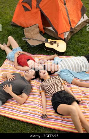 Glückliche junge Freunde, die im Freien campen Stockfoto