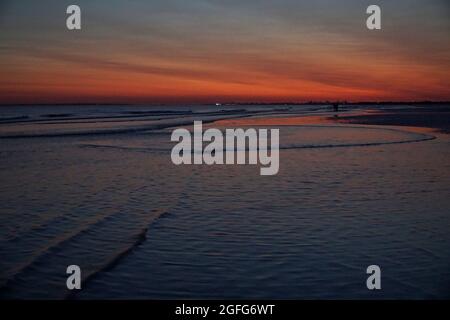 Wetter in Großbritannien, 25. August 2021: Unter hohem Druck über Großbritannien folgte der klare Himmel den ganzen Tag über einem spektakulären roten Himmel nach Sonnenuntergang, der hier vom East Wittering Beach in West Sussex aus in Richtung Portsmouth und Solent gesehen wurde. Anna Watson/Alamy Live News Stockfoto