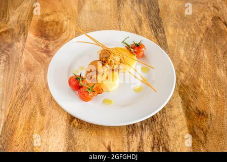 Hackbraten mit Kartoffeln und Kirschtomaten auf weißem Teller Stockfoto