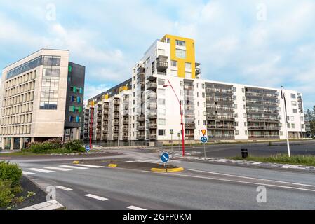 Moderne Apartmentgebäude in einem Wohnviertel. Ein Kreisverkehr ist im Vordergrund. Stockfoto