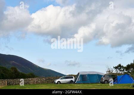 Zeltlager auf einem Farmfeld im Lake District gegenüber der Blencathra (Saddleback) fielen an einem bewölkten, nebligen Sommertag. Stockfoto