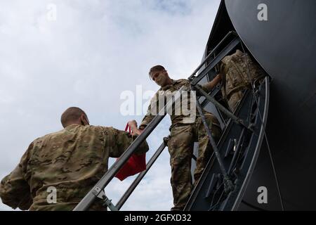 First LT. Cole Wolf, rechts, und Maj. Zackery Williams, beide 9. Airlift Squadron-Piloten, laden Taschen auf eine C-5M Super Galaxy, bevor sie vom Dover Air Force Base, Delaware, 16. August 2021 zum Hamid Karzai International Airport, Afghanistan, fliegen. Air Mobility Airmen spielen eine Schlüsselrolle bei der Erleichterung der sicheren Ausreise und Umsiedlung von US-Bürgern, Empfängern von Sondereinreisevisa und gefährdeten afghanischen Bevölkerungen aus Afghanistan. (USA Luftwaffe Foto von Senior Airman Faith Schaefer) Stockfoto