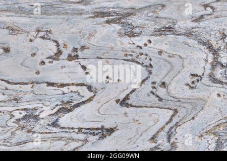 Hintergrund grau Stein Muster Oberfläche. Felsstruktur mit geschwungener Linie. Stockfoto