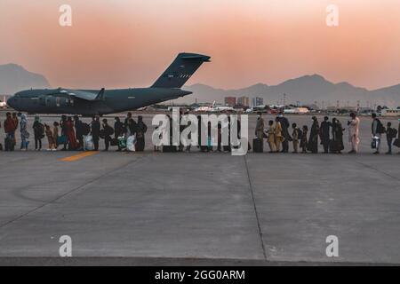 Kabul, Afghanistan. August 2021. Evakuierte warten während einer Evakuierung auf dem Hamid Karzai International Airport am 23. August 2021 in Kabul, Afghanistan, auf das Einsteigen in eine Boeing C-17 Globemaster III. US-Streitkräfte und alliierte Streitkräfte evakuieren weiterhin Bürger und Inhaber von Visa für besondere Zwecke im Rahmen der Operation Allies Refuge. Quelle: Planetpix/Alamy Live News Stockfoto