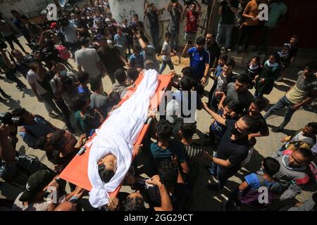 Gaza, Der Gazastreifen, Palästina. August 2021. Ein Verwandter trauert um Hassan Abu al-Neil Abu al-Neil, ein 12-jähriger palästinensischer Junge, der letzte Woche bei einer Demonstration an der Grenze zwischen Gaza und Israel durch ein israelisches Feuer in den Kopf geschossen wurde, starb am Samstag an seinen Verletzungen. (Bild: © Mahmoud Khattab/Quds Net News via ZUMA Press Wire) Stockfoto